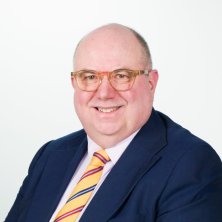 Andrew Nicholls in suit and tie