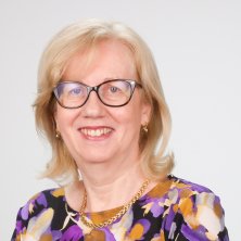Carmel Donnelly in a orange and purple top, wearing glasses