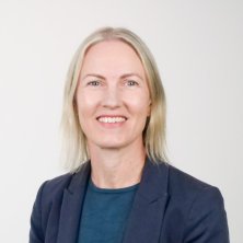 Kelly Kwan in a dark suit