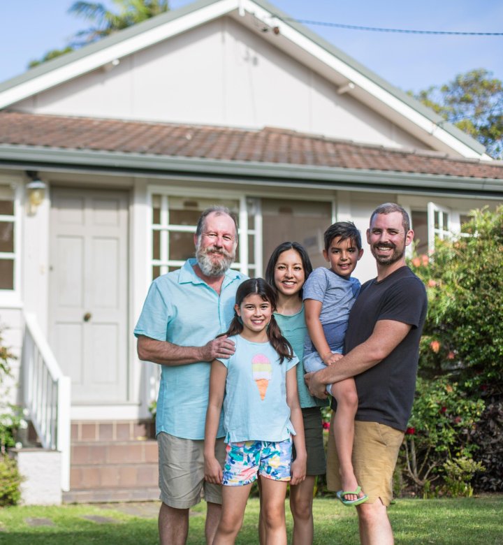 Family standing outside their home