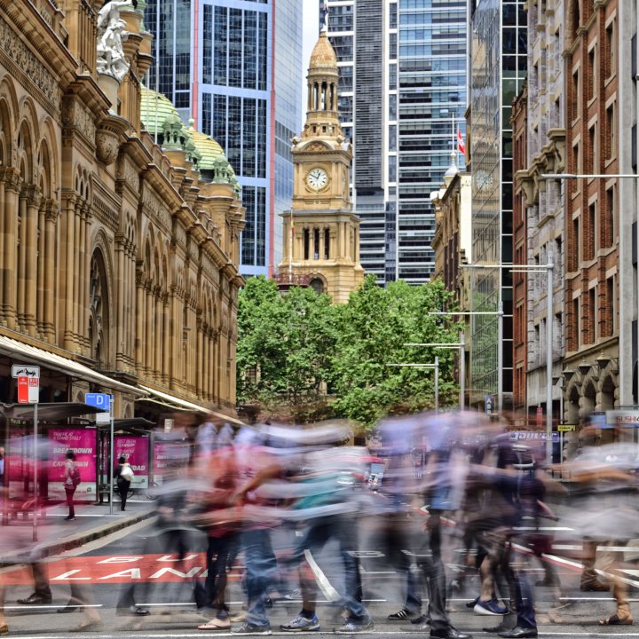 Street day scene of people walkling sydney cbd queen victoria building and town hall tower